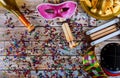 Purim traditional with hamantaschen cookies, noisemaker and carnival mask on wood background