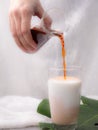 Puring tea in milk glass Royalty Free Stock Photo