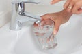 Puring in water in a glass Royalty Free Stock Photo