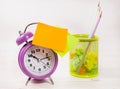 The purple alarm clock has an orange blank sticker. Business planning and development concept Royalty Free Stock Photo