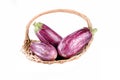 Purple aubergines in a straw basket