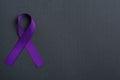 Purple awareness ribbon on black background, space for text Royalty Free Stock Photo