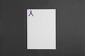 Purple awareness ribbon and blank card on black background, top view Royalty Free Stock Photo