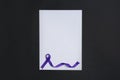 Purple awareness ribbon and blank card on black background, top view Royalty Free Stock Photo