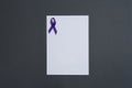 Purple awareness ribbon and blank card on black background, top view with space for Royalty Free Stock Photo