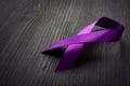 Purple awareness ribbon on the desk. Pancreatic cancer Royalty Free Stock Photo