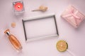 Purple background with frame for photo, gift box, candle and perfume, with empty space Royalty Free Stock Photo