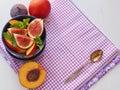 Purple background. Fruit salad in a blue vase with fresh fruits. Copy space for your text. Selective focus. Royalty Free Stock Photo