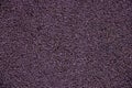 Purple background from rubber coating of a sports ground.