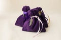 Purple bags with energy stones inside on a table Royalty Free Stock Photo