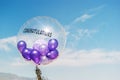 purple balloons in big balloon congratulations on blue sky with Royalty Free Stock Photo