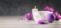 purple bath bomb, sea salt crystals, towel and scented candles on wooden table. wellness spa center. banner Royalty Free Stock Photo