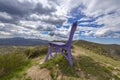 Purple big bench in the inland of Genoa in the countryside under a cloudy sky, Italy Royalty Free Stock Photo