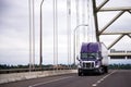 Purple big rig semi truck with dry van trailer for long haul car