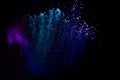 Purple blue color powder explosion cloud  on black background.Closeup of purple blue dust particles splash Royalty Free Stock Photo