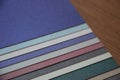 Purple blue grey teal mint background texture of colored paper on wooden table Royalty Free Stock Photo