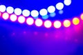 Purple blue neon garlands of bokeh lights and reflections. Festive Abstract background of 80s colors Royalty Free Stock Photo