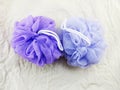 Purple and blue plastic bath puff for shower cleaning and scrub body Royalty Free Stock Photo