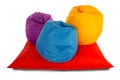 Purple, blue and yellow beanbag chairs on red beanbag sofa Royalty Free Stock Photo