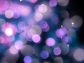 Purple blurred round shiny blurred lights abstract with bright sparkles on a black background Royalty Free Stock Photo