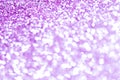 Purple bokeh texture. Festive glitter background with defocused lights Royalty Free Stock Photo