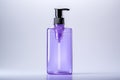 Purple bottle of liquid soap or sanitizer on a white background