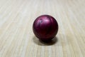 Purple bowling ball on the track in the bowling center Royalty Free Stock Photo