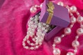 Purple box with pink pearl strands closeup Royalty Free Stock Photo