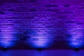 A Purple Brick Wall With Three Blue Lights