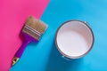 Purple brush with open can of white paint on blue and pink neon background. Trend concept Royalty Free Stock Photo