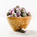 Purple Brussels sprouts in a wooden bowl Royalty Free Stock Photo