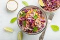 Purple cabbage and carrot salad with mayonnaise in a white bowl on a light background. Classic coleslaw. Diet vegetarian