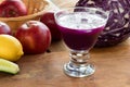 Purple cabbage juice in a glass, with cabbage and apples in the Royalty Free Stock Photo