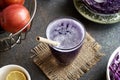 Purple cabbage juice in a glass with bamboo straw and apples Royalty Free Stock Photo