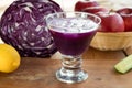 Purple cabbage juice in a glass on a wooden table Royalty Free Stock Photo