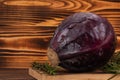 Purple cabbage and rosemary on cutting board, wooden background. Fresh vegetables, healthy organic food Royalty Free Stock Photo
