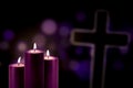 Purple candles with a cross symbol