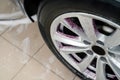 Purple car rim cleaner on the vehicle wheel. Professional auto detailing.