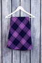 Purple checkered skirt on hanger.