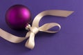 Purple christmas ball with grey ribbon Royalty Free Stock Photo