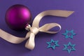 Purple christmas ball with stars and grey ribbon Royalty Free Stock Photo