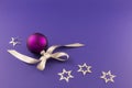 Purple christmas ball with stars and grey ribbon Royalty Free Stock Photo