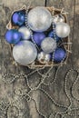 purple Christmas balls and silver, beads lie in a wooden basket Royalty Free Stock Photo