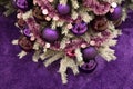 Purple Christmas ornaments and violet tinsel garlands on artificial Christmas tree with purple fur background. Matte and glossy Royalty Free Stock Photo