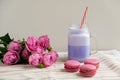 Purple coffee in stylized mason jar cup with macarons and roses and colorful decoration. Blueberry milk shake. Unicorn coffee. Royalty Free Stock Photo