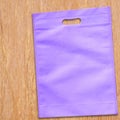 Purple Color D-cut fabric bag on table. Royalty Free Stock Photo