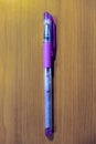 Purple color pen on wooden background Royalty Free Stock Photo