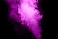 Purple color powder explosion on black background. Mauve purple color cloud. Purple dust splash