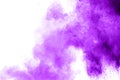 Purple color powder explosion cloud  on white background.Closeup of purple dust particles splash on background Royalty Free Stock Photo