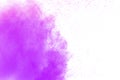 Purple color powder explosion cloud on white background.Closeup of Purple dust particles splash on background Royalty Free Stock Photo